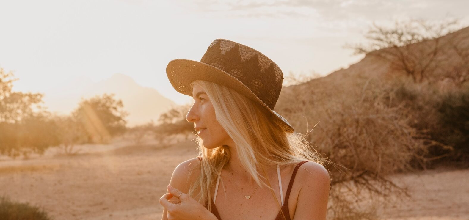 Namibia, Spitzkoppe, woman with hat at sunset